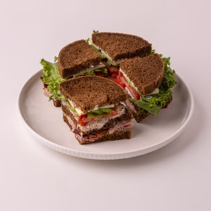 This double-decker is stacked with turkey breast, ham, crisp bacon, Jarlsberg cheese and lettuce and tomato with our mustard sauce and mayonnaise on pumpernickel.