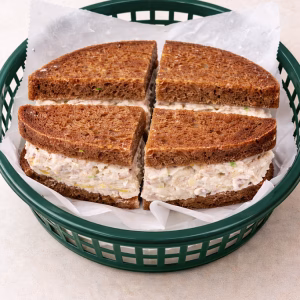 Tender pulled white meat chicken tossed with crisp red onion and fresh celery, sweet bites of dried apricots, and crunchy toasted almonds. Lightly seasoned, then finished with a touch of honey and mayo. Served on pumpernickel bread. Â