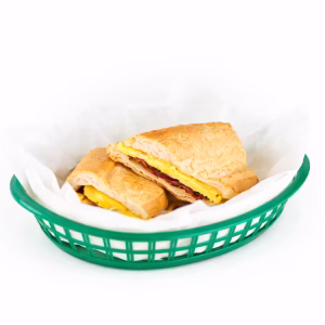 Scrambled egg, bacon, and cheddar cheese on Cuban toast.